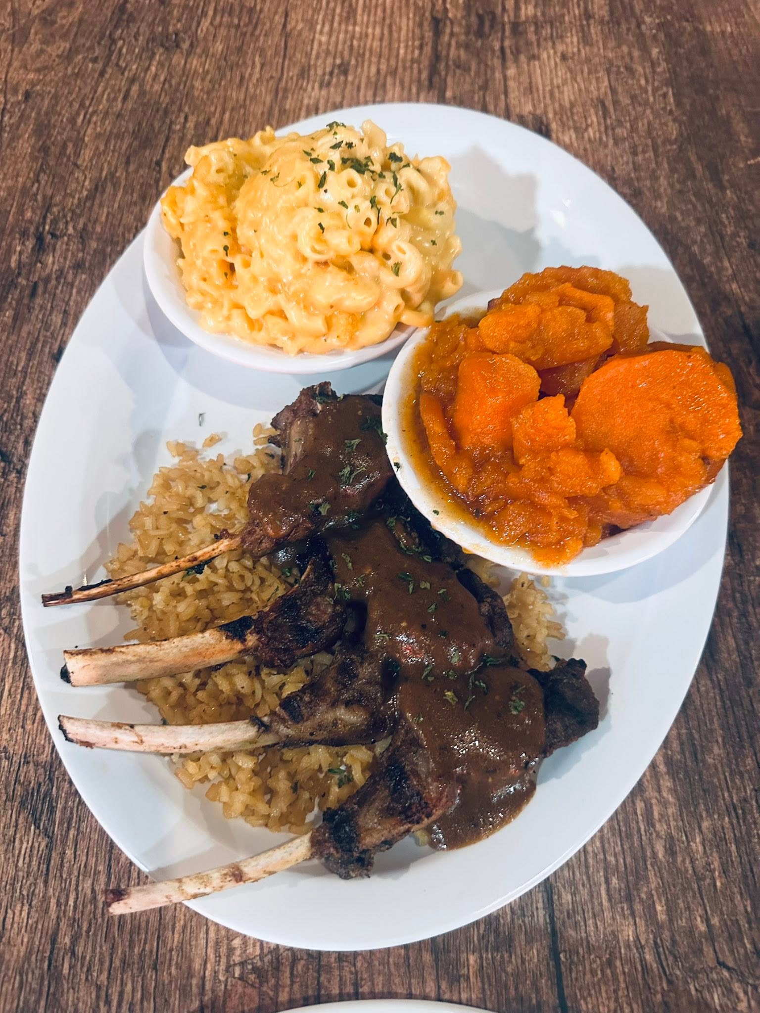 Grilled lamb chops with rice, candied yams, and mac and cheese